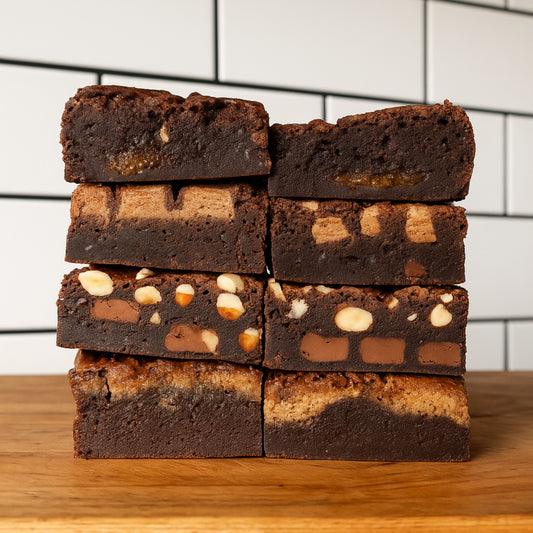 Stack of brownies with visible layers on a wooden surface and tiled wall background