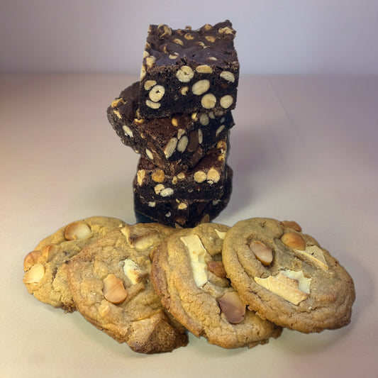 Stack of brownies and cookies on a light background